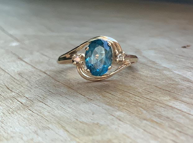 14ct Gold Swiss blue Topaz and Diamond ring that comes with a copy of a jewellers valuation for replacement cost of $1292